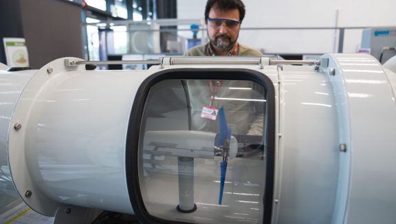 A lecturer sets up equipment for use in a low carbon energy technology workshop