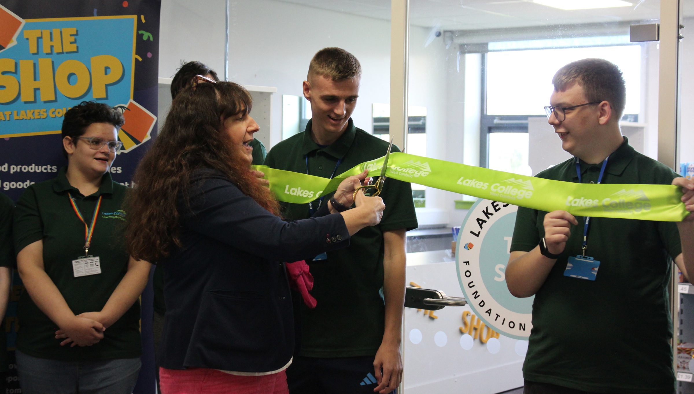 A woman cuts a ribbon to open a new shop