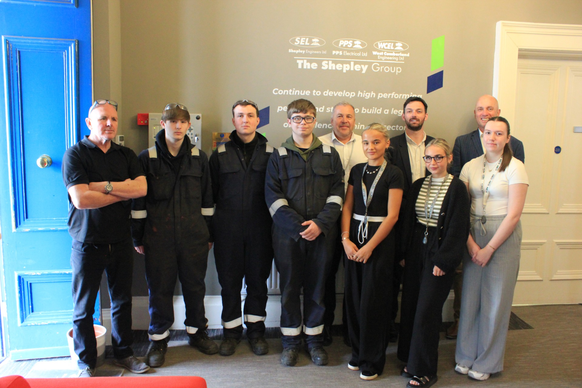 A group of apprentices stand together at The Shepley group HQ